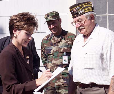 Heather French signs an autograph for a veteran at Fort McCoy